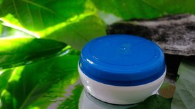 Mockup container, beauty product,  blue and white, sunlight refraction on wet mirror surface.  Tropical nature. Wellness beauty product , mockup and beauty concept. - Powered by Shutterstock - Get 15% off with code: PIKWIZARD15