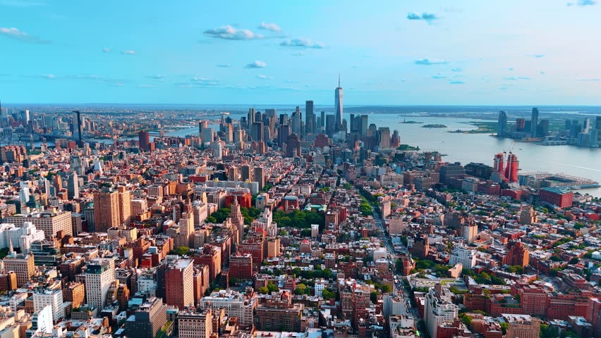 Beautiful diverse urban panorama of New York crossed by the East River. View on a stunning high-rise Manhattan at backdrop.