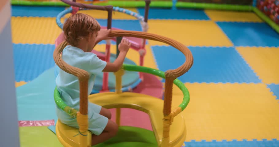 Child Playing on Colorful Indoor Playground Equipment