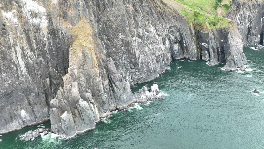 The Pacific Ocean washes against the rugged, rocky shoreline of northern Oregon, just south of Cannon Beach. This part of the Pacific Northwest has incredibly scenic coastlines and beaches.