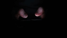 Fingers glow faintly from screen light in complete darkness highlighting quiet solitude concentration and the hypnotic pull of digital content at night - Powered by Shutterstock - Get 15% off with code: PIKWIZARD15