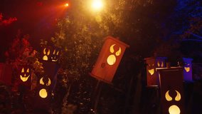 Brightly colored Halloween lanterns cast a warm glow, illuminating a magical forest that creates an enchanting atmosphere ideal for enjoying the festive celebrations alongside loved ones and friends - Powered by Shutterstock - Get 15% off with code: PIKWIZARD15