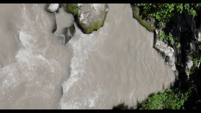 Vertical 4k high quality footage of muddy glacier-fed Whitewater Creek flowing through mossy rocks and fallen logs in Mount Jefferson Wilderness, Oregon.Rushing alpine water in a rugged forest setting - Powered by Shutterstock - Get 15% off with code: PIKWIZARD15
