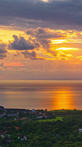 Sunset light reflecting on the sea near peaceful village. Timelapse