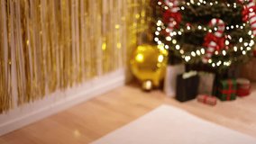 A Defocused Wide Shot Of A Christmas Tree With Golden Tinsel Wall And Blurred Lights
Festive interior with a decorated Christmas tree in the background, candy cane ornaments, and a golden tinsel wall - Powered by Shutterstock - Get 15% off with code: PIKWIZARD15