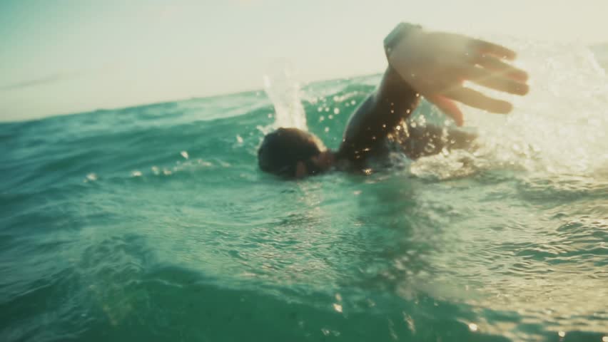 Swimmer In Wetsuit Doing Freestyle Stroke In Open Water. Aquatic Sport Exercises. Professional Athlete Training. Sport Triathlon Preparation Competitive Swimming. Summer Swimming Fitness And Endurance Water Sports Aquatic Workout. Endurance Sport.