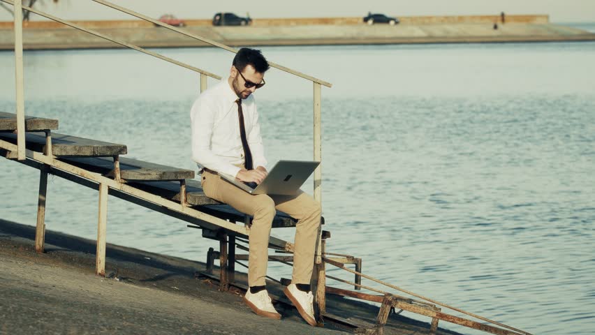 Businessman Working On Laptop Outdoors. Remote Work Lifestyle. Digital Nomad Outdoor Office. Flexible Job Mobile Computing. Freelance Career Remote Connectivity.Global Workplace Entrepreneur Lifestyle - Powered by Shutterstock - Get 15% off with code: PIKWIZARD15