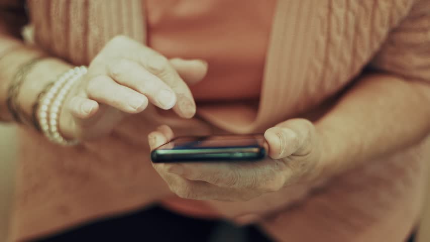 Mature Hands Using Smartphone. Senior Woman Texting.Technology For Seniors. Active Senior Staying Connected. Online Communication Connecting With Family.Digital Literacy Browsing Internet Smart Device