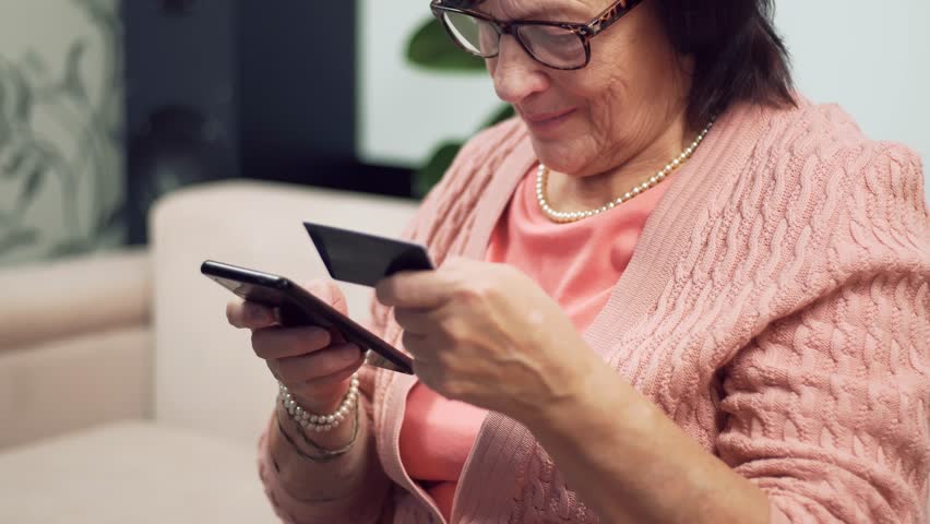 Senior Woman Making Online Purchase With Smartphone And Credit Card. Digital Banking Mobile Payment. Online Transaction Secure Shopping. Browse E-shop Electronic Payment. Trustworthy Convenient Buying - Powered by Shutterstock - Get 15% off with code: PIKWIZARD15
