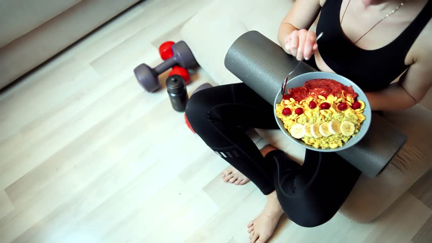 Woman Eating Healthy Post-Workout Meal. Fitness Lifestyle And Nutrition. Wellness And Exercise Routine. Balanced Diet Athletes. Healthy Eating Habits Active Living Journey.Post-Exercise Balanced Diet