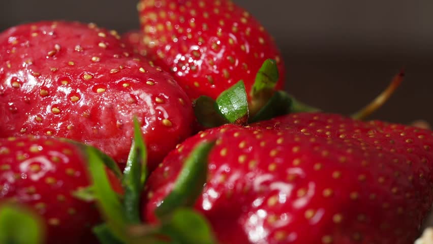 Freshly picked strawberries displayed on a wooden table