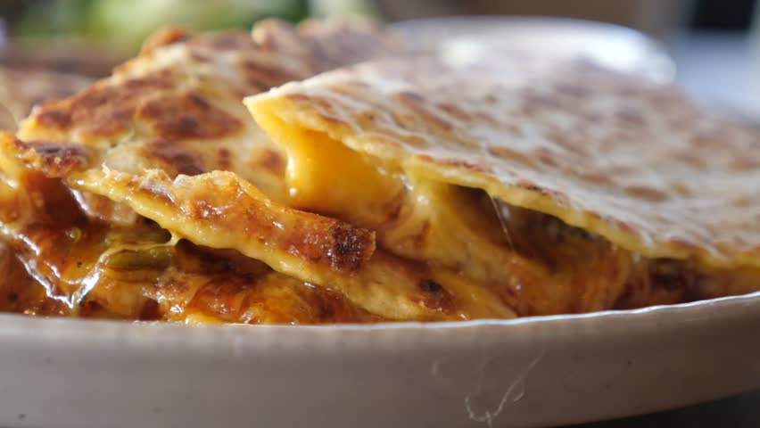 Delicious melted cheese quesadilla served with fresh toppings