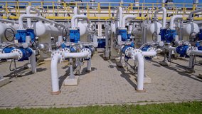 Front view of industrial gas pipelines and control valves at an energy facility in Riga. Riga, Latvia - Powered by Shutterstock - Get 15% off with code: PIKWIZARD15