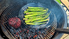 Vegetables on grill with visible char lines and green asparagus cooking over flame - Powered by Shutterstock - Get 15% off with code: PIKWIZARD15