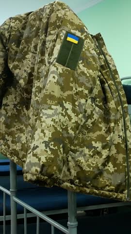 Barracks in the Ukrainian army. The Soldiers' Room has bunk beds. Military uniforms hang on the beds. Ukraine is defending its territory from a Russian attack. Real War 2022. Ukraine as a candidate