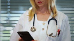 Female doctor on phone with warning message animation. EHR and EMR data theft and cybersecurity risks in healthcare - Powered by Shutterstock - Get 15% off with code: PIKWIZARD15