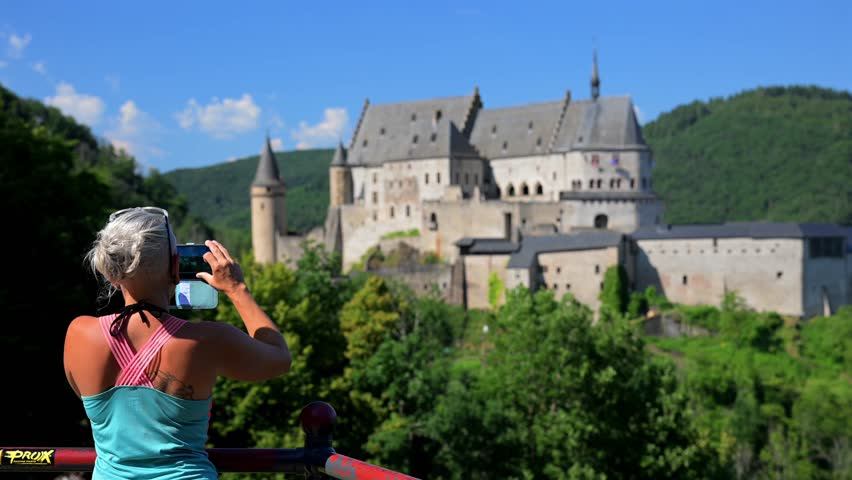Female traveller visiting Vianden Castle during summer in Luxembourg	