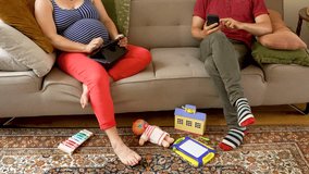 Expectant Wife and Husband Relaxing on Couch with Digital Devices - Powered by Shutterstock - Get 15% off with code: PIKWIZARD15