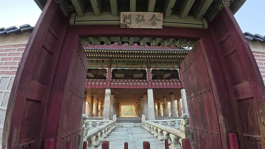 Gyeonghoeru Pavilion At Gyeongbokgung Palace In Seoul - Elevated Banquet Hall On Artificial Pond Viewed Through Open Wooden Gates. POV shot