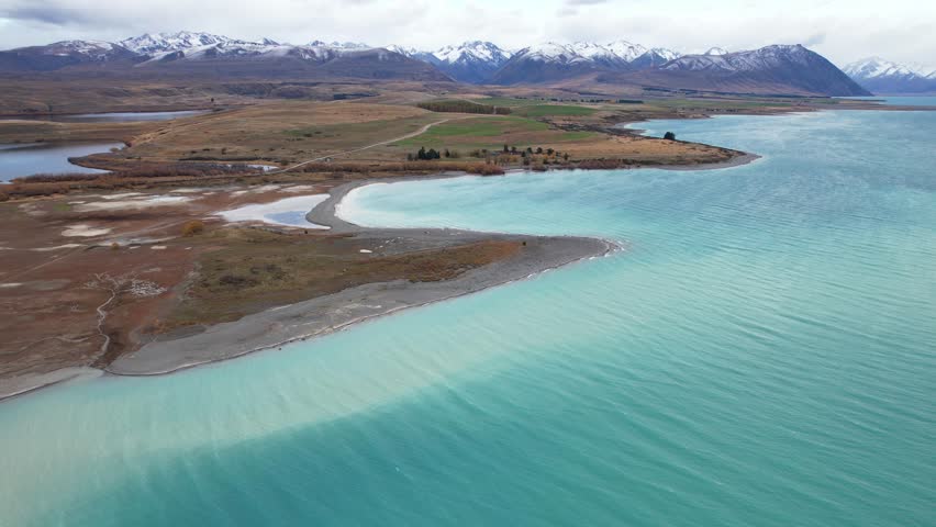 Turquoise Water Of Lake Tekapo In Daytime In Canterbury, South Island, New Zealand. - aerial shot