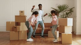 Family joyfully celebrates new home while unpacking moving boxes together - Powered by Shutterstock - Get 15% off with code: PIKWIZARD15
