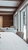 A vertical revealing shot showcases the beautiful interior design of a modern rustic log cabin in Latvia, featuring exposed wooden beams, a cozy fireplace, and a table with Christmas decorations. - Powered by Shutterstock - Get 15% off with code: PIKWIZARD15