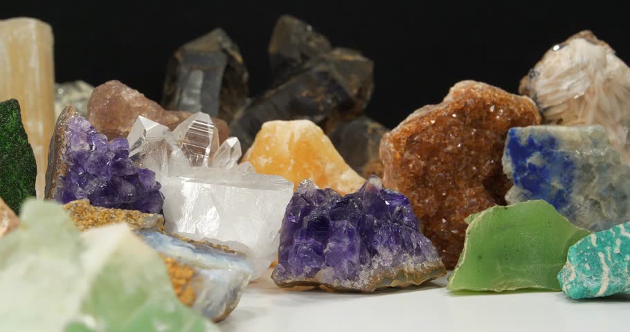 Natural Semi Precious stones and minerals, riches of Earth. Green garnet, purple Amethysts, Quartz crystals, blue Lazurite, green Nephrite and Amazon stone, yellow Citrine, Barite and golden Pyrite