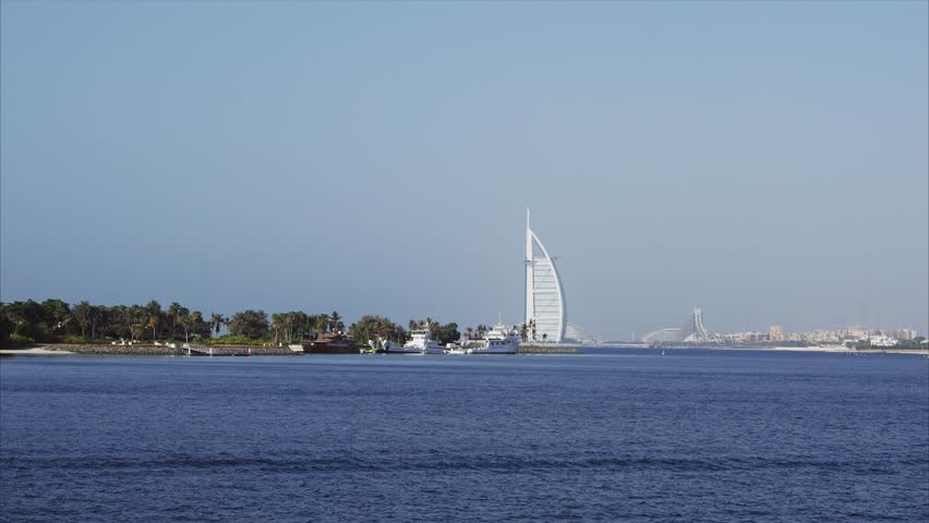 Panoramic view of Eco park island with backround view of the iconic Burj Al Arab surrounded by calming sea waters