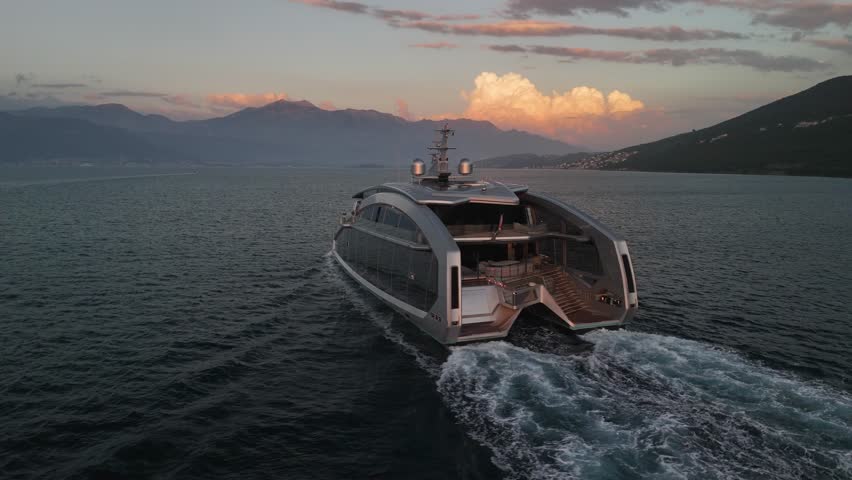 Low aerial shows classy design of unique catamaran motor yacht on sea