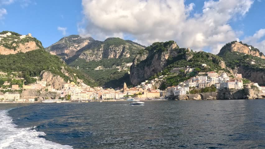 Landscape with Amalfi town at famous Amalfi Coast, Italy. Scenic Amalfi Coast with stunning mountains and charming coastal towns. Seacoast of Amalfi. 
