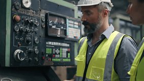 An engineer foreman explaining and training trainee worker about factory machinery at construction site. Operating big machine, inspecting qualtiy control before running work. - Powered by Shutterstock - Get 15% off with code: PIKWIZARD15