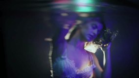 Fantasy water photography: beautiful woman's face seen through ripples with magical lighting - Powered by Shutterstock - Get 15% off with code: PIKWIZARD15