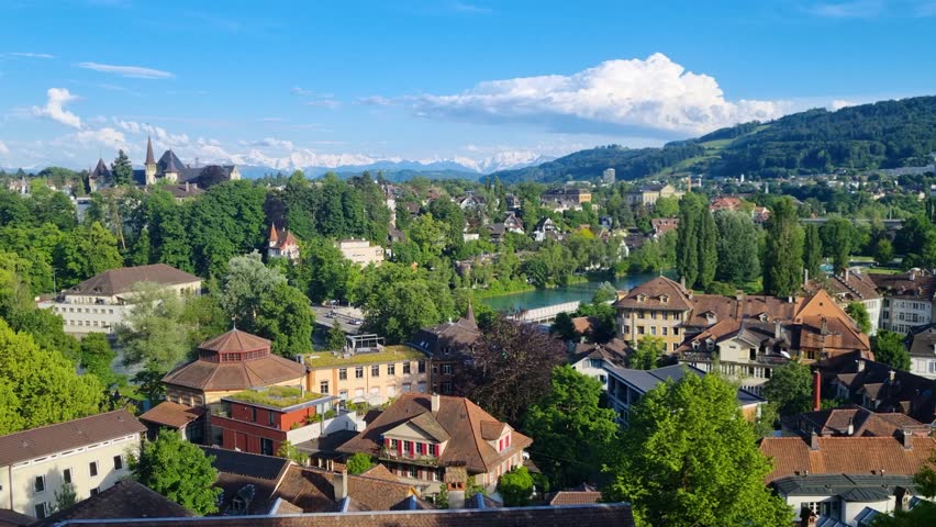 Stunning panoramic view from the Bundes­terrasse in Bern, Switzerland, overlooking the Swiss capital and distant Alpine mountains on a bright and clear summer day