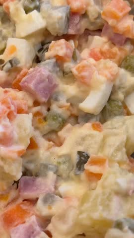 Traditional Olivier salad with diced vegetables and ham, commonly served during New Year celebrations video