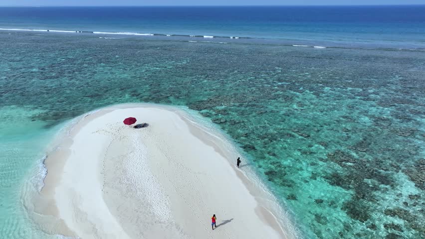 Aerial view of a pristine sandbank with turquoise water contrasts against the white sand, inviting exploration and relaxation, Thoddoo, Alif Alif Atoll, Maldives.