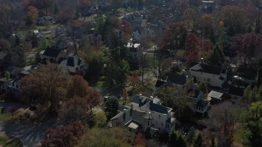 Aerial view of houses nestled among the trees, with vibrant foliage adding warm hues, in Observatory Place, Cincinnati, Ohio, United States.