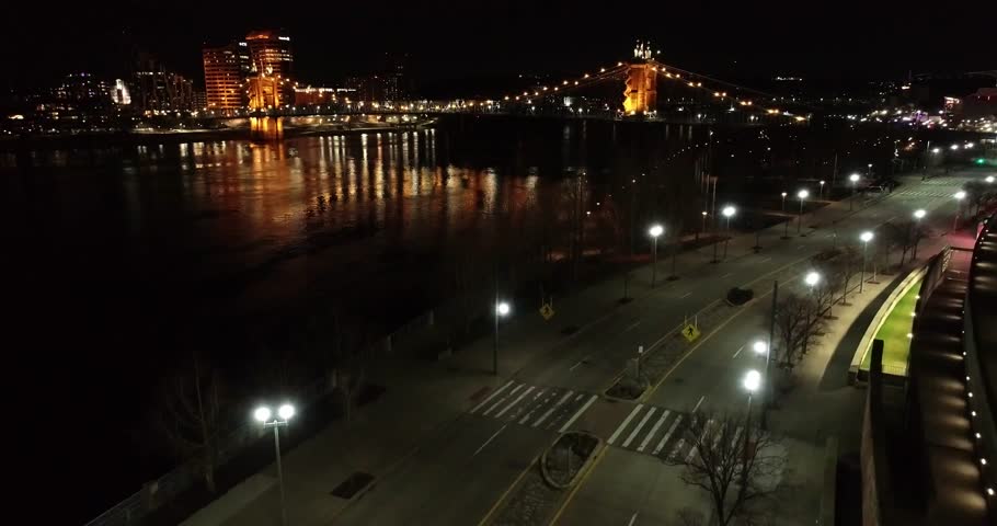 Aerial view of the John A. Roebling Suspension Bridge and the cityscape reflecting on the water at night, Cincinnati, Ohio, United States.