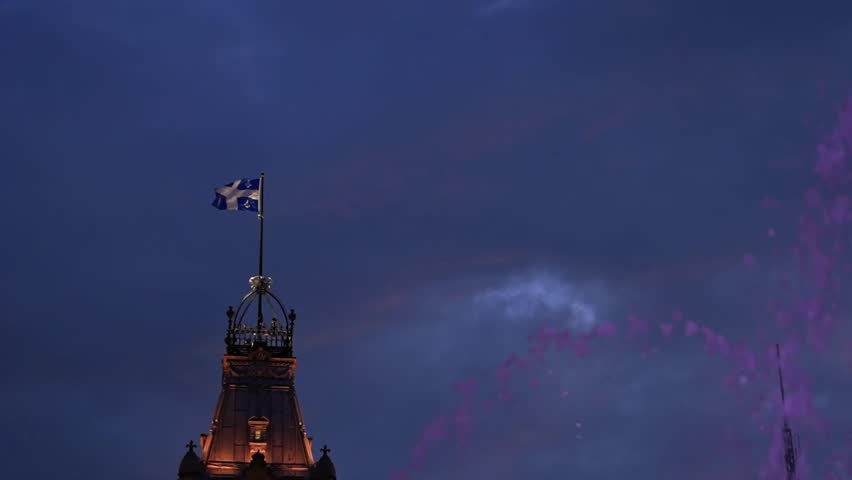 Horizontal video of Fontaine de Tourny with the illuminated Quebec Parliament Building at dusk.