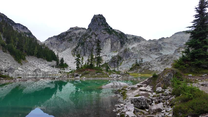 Watersprite Lake: Tranquil Turquoise Waters Reflecting Majestic Mountains in British Columbia, Canada.