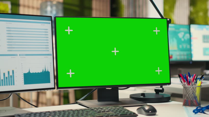 Empty modern office space presents dual monitors and green screen on display, showcases high tech tools essential for business planning and operational development. Performance insights.