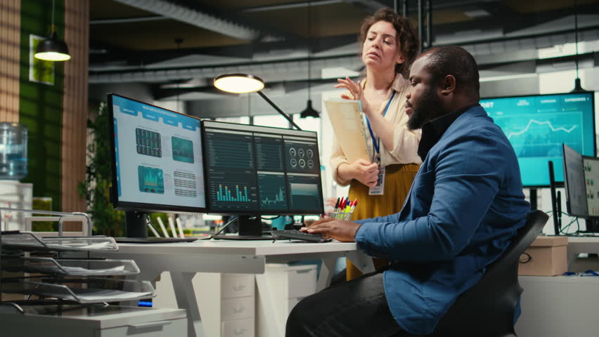 Colleagues engaging in discussion and consulting around performance metrics, leveraging insights to align objectives and achieve business goals efficiently in a multinational company. Camera A.