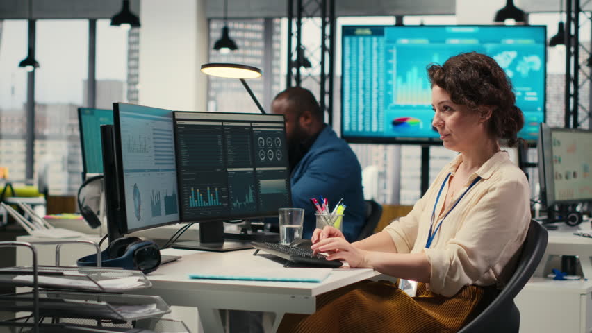 Female business analyst leverages insights and report writing for forecast results and corporate development, utilizing financial data charts for strategic alignment with objectives. Camera B.