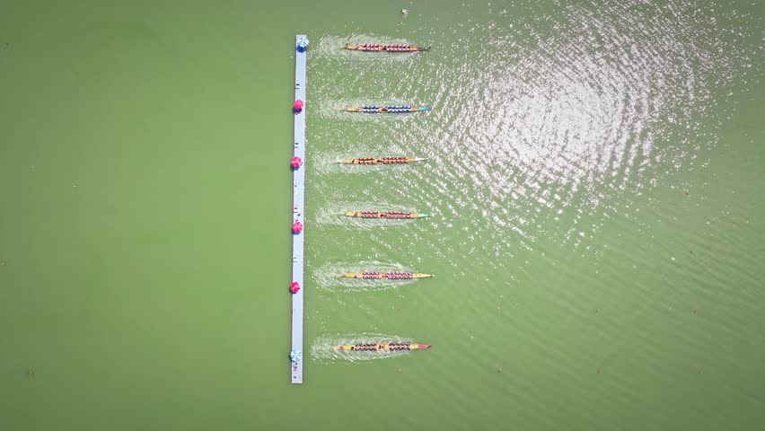 Dragon Boat team rowing to the pace of an onboard Drummer