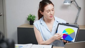 Young asian businesswoman presentation financial report on tablet with marketing and explaining graph and chart in home office, online meeting, data analysis of finance, business presenting. - Powered by Shutterstock - Get 15% off with code: PIKWIZARD15
