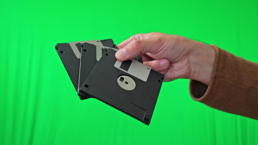 A nostalgic and technical mood is captured as a hand holds a fanned stack of classic 3.5-inch floppy disks, ready for integration into various digital or historical themes - Powered by Shutterstock - Get 15% off with code: PIKWIZARD15