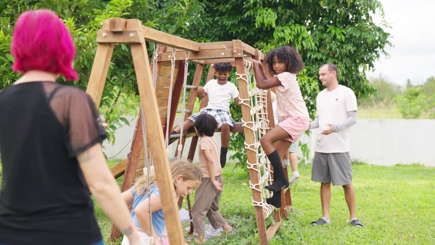 Group of Happy diversity school student boy and girl enjoy and fun outdoor active lifestyle playing outside classroom in sunny day. Teacher watching over children playing on playground for safety.