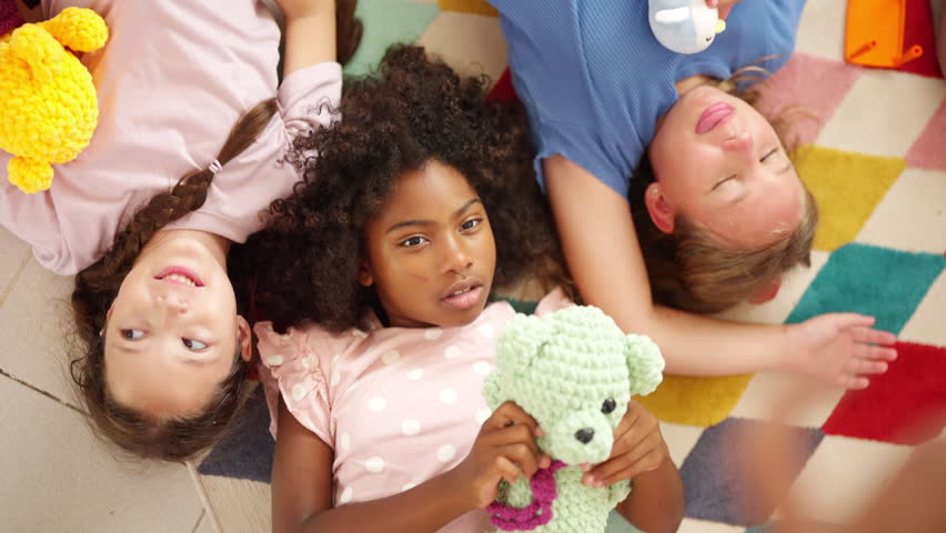 Portrait of Happy diverse children girl friends playing doll together in classroom. School student enjoy and fun learning, studying and playing for development knowledge education at primary school.