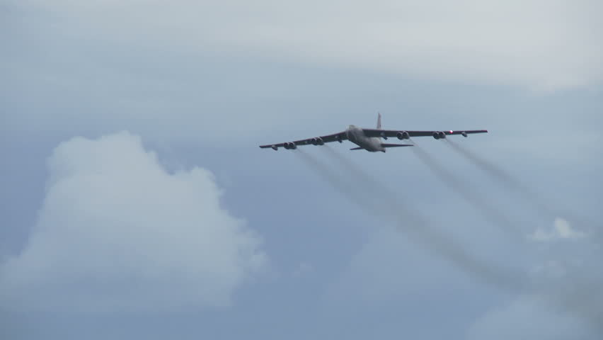 Boeing B-52 Stratofortress, military bomber flying overhead.