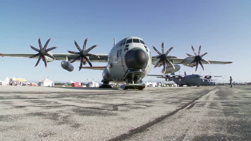 Lockheed Hercules military transport aircraft parked at an airshow.  Two clips with camera dolly.