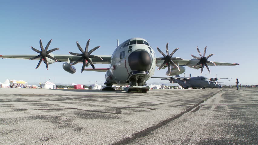 Lockheed Hercules military transport aircraft parked at an airshow.  Two clips